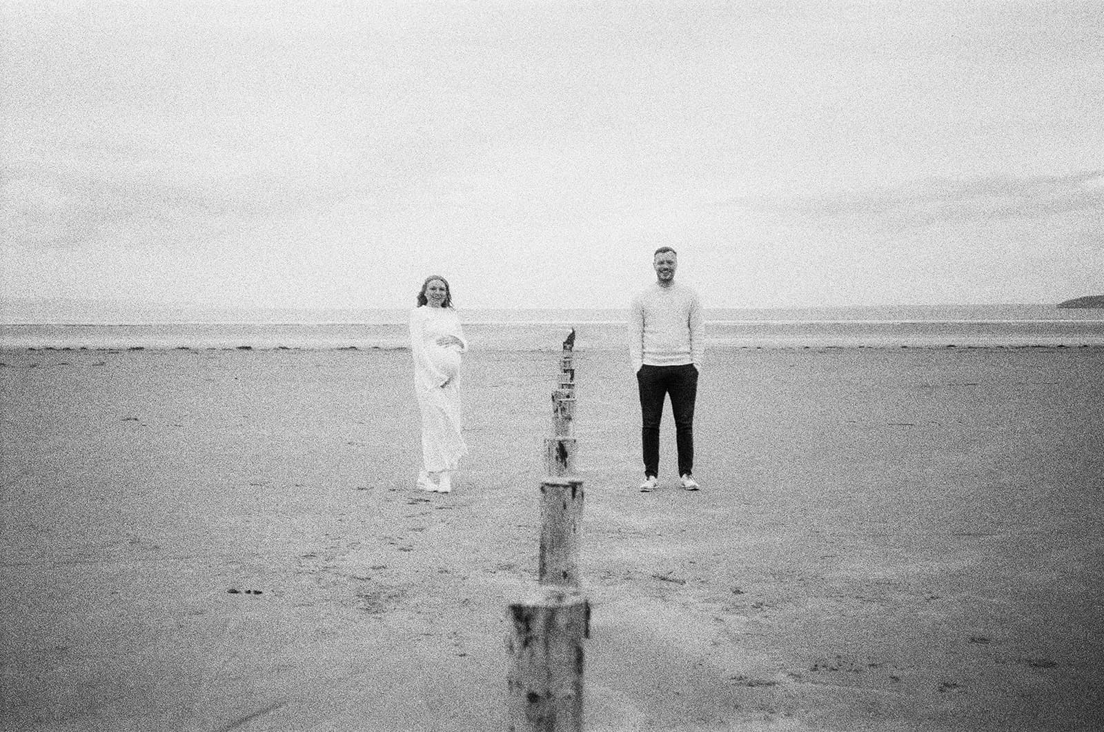 Maternity film photography, 35mm, brean beach, couple standing next to eachother
