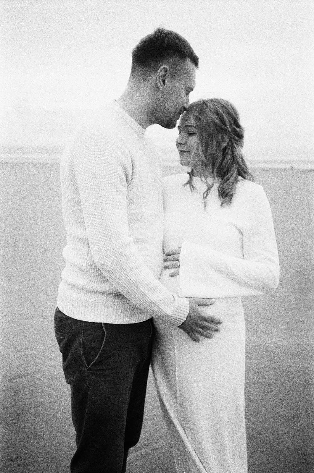 Maternity film photography, 35mm, brean beach, couple standing next to eachother