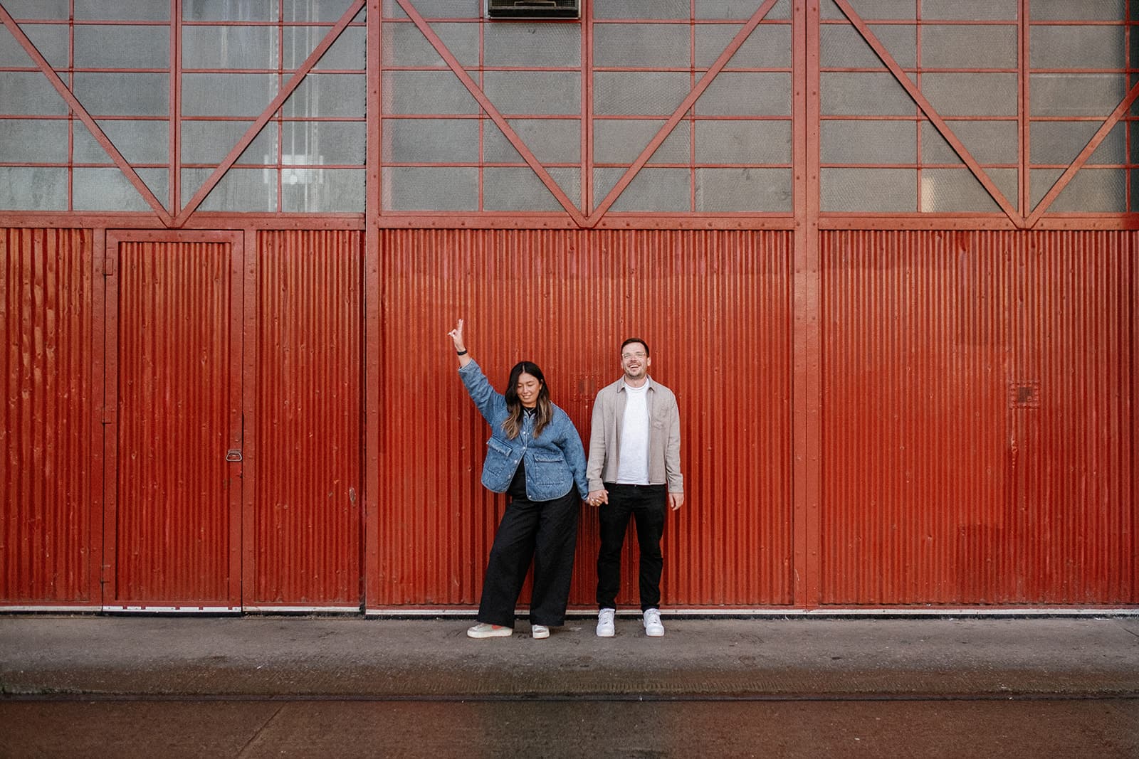 Two people standing in front of a red, patterned door, Mshed, Bristol.