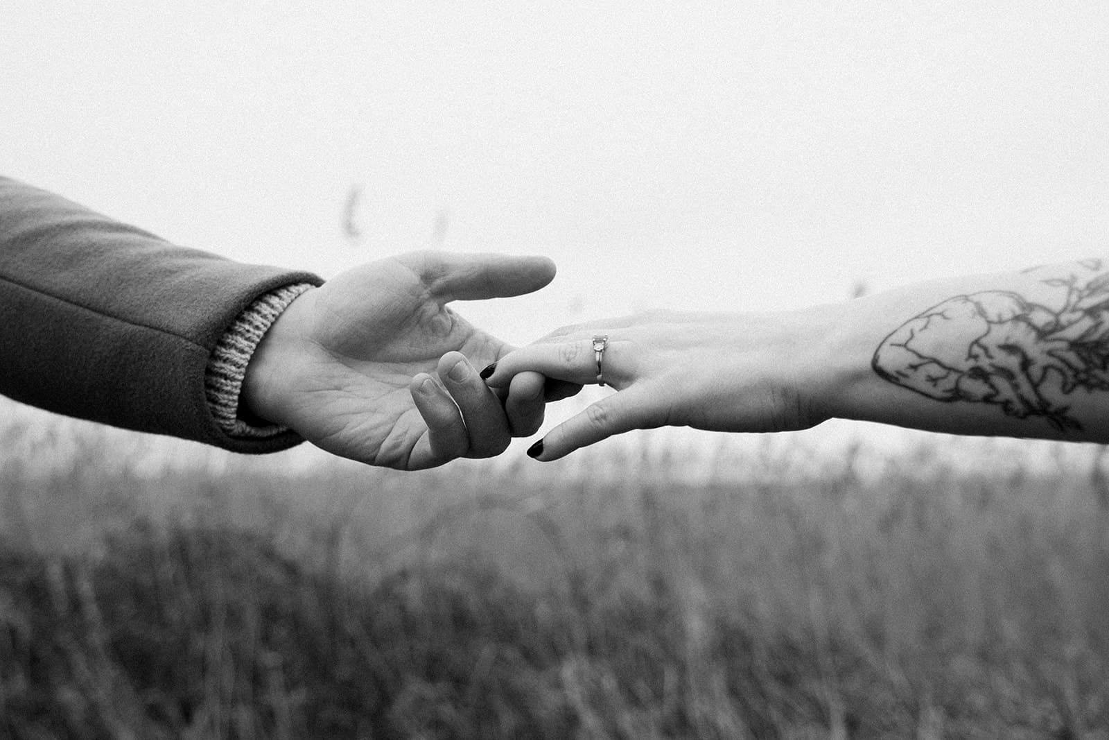East Usk Lighthouse, couple session, digital photograph, in black and white, hands reaching out for each other
