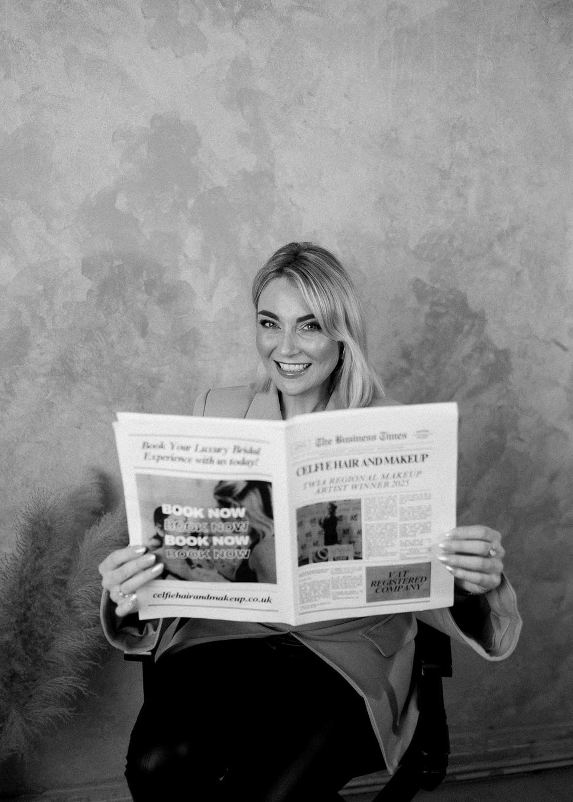Person holding a newspaper with ads visible.