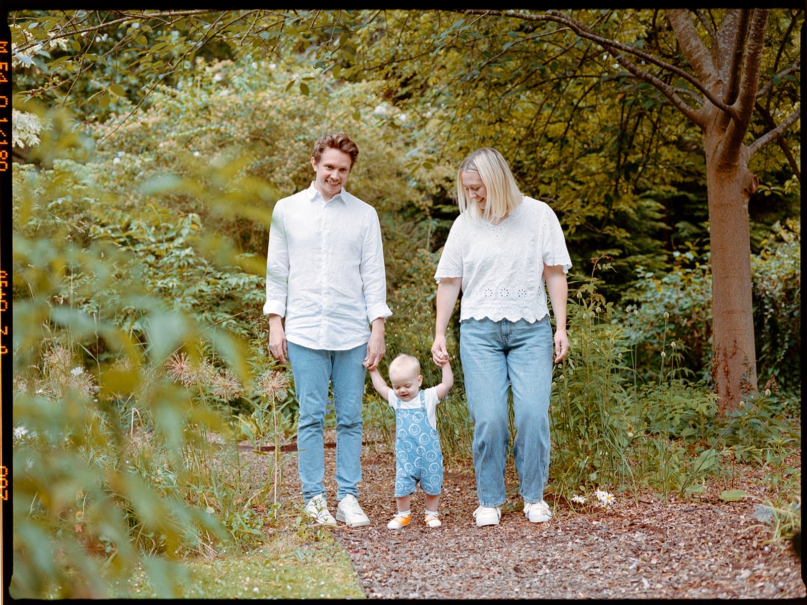 film photo of family in bath holding hands in park